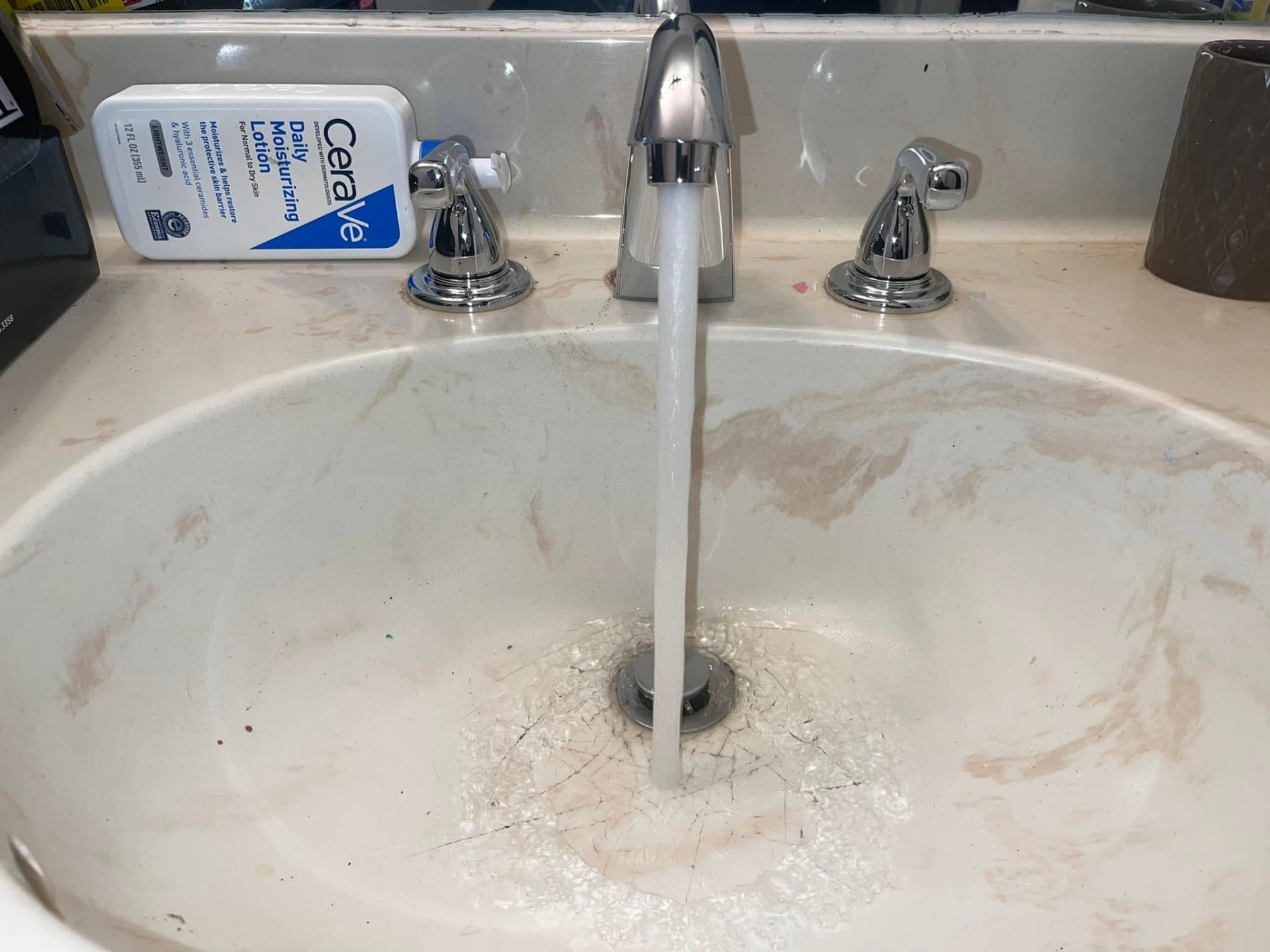 Newly installed chrome bathroom faucet running water after replacement
